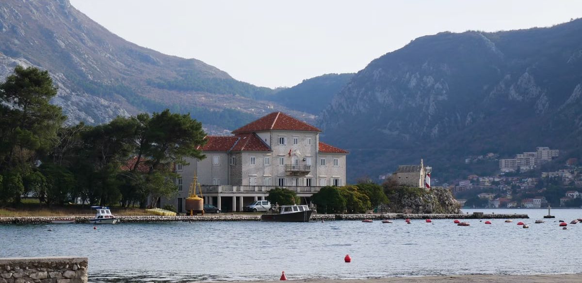 Beautiful coastal landscape of Montenegro with historic architecture and mountains.